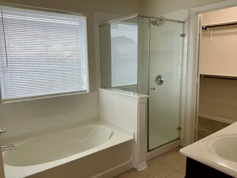 a bathroom with a bathtub and a shower