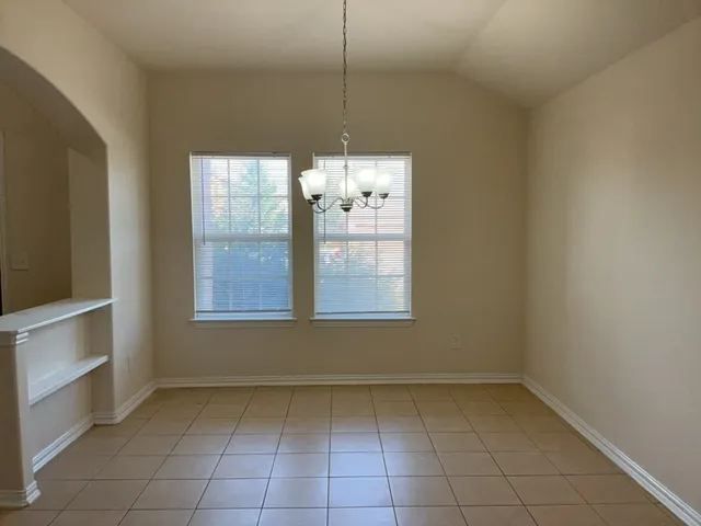 a view of a kitchen with a dishwasher cabinets and a window