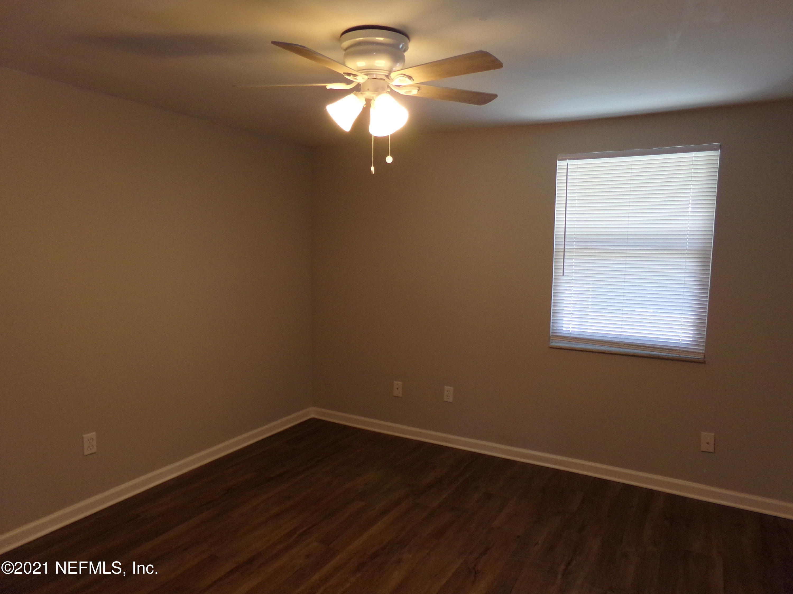 2652 Sunrise Village Drive, Unit C Orange Park, FL 32065 - Photo 6 of 7 a view of an empty room with window and wooden floor