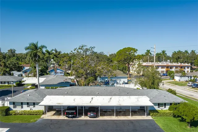 a view of a town with brick building and large tree