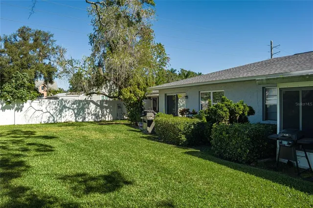 a front view of house with a garden