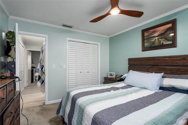 a bedroom with a bed and a painting on the wall