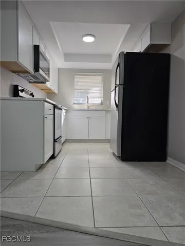 a kitchen with a refrigerator and window