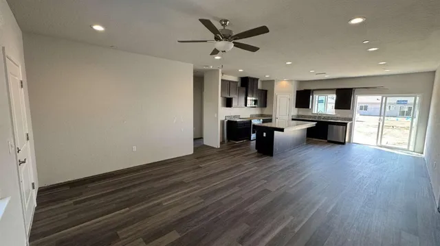 a kitchen with granite countertop kitchen island wooden cabinets and stainless steel appliances