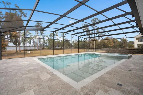 a view of a house with a small yard and sitting area