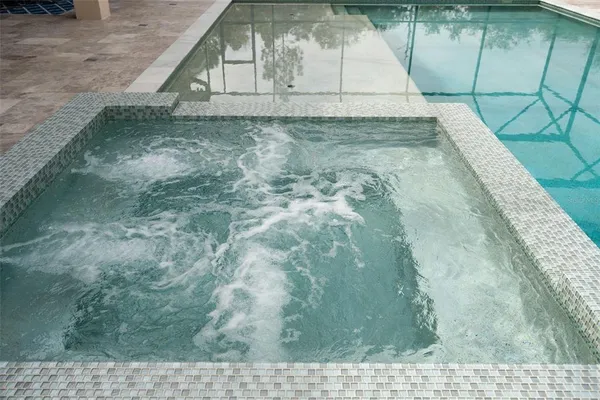a view of a balcony with wooden floor and fence