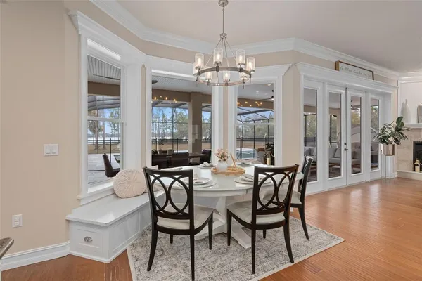 a kitchen with stainless steel appliances granite countertop a refrigerator a stove top oven and a center island with wooden floor