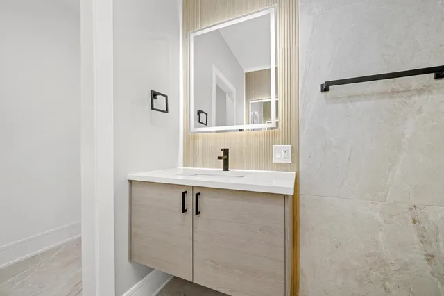 a bathroom with a shower and a sink