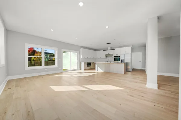 a view of a kitchen with a sink and a refrigerator