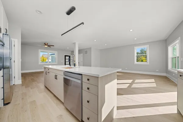 a kitchen with granite countertop white cabinets and white appliances