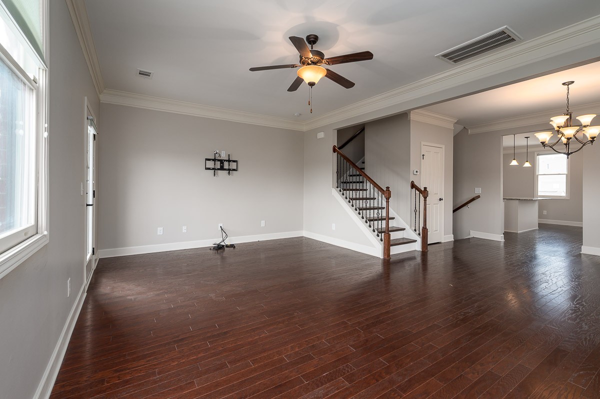 2069 Rural Plains Circle Franklin, TN 37064 - Photo 11 of 34 a view of an empty room with wooden floor and a ceiling fan