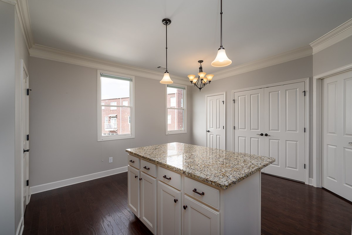 2069 Rural Plains Circle Franklin, TN 37064 - Photo 16 of 34 a kitchen with granite countertop stove and wooden floor