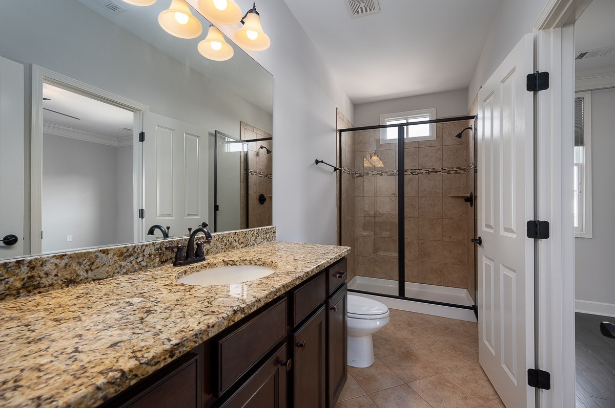 2069 Rural Plains Circle Franklin, TN 37064 - Photo 21 of 34 a bathroom with a granite countertop sink and a mirror