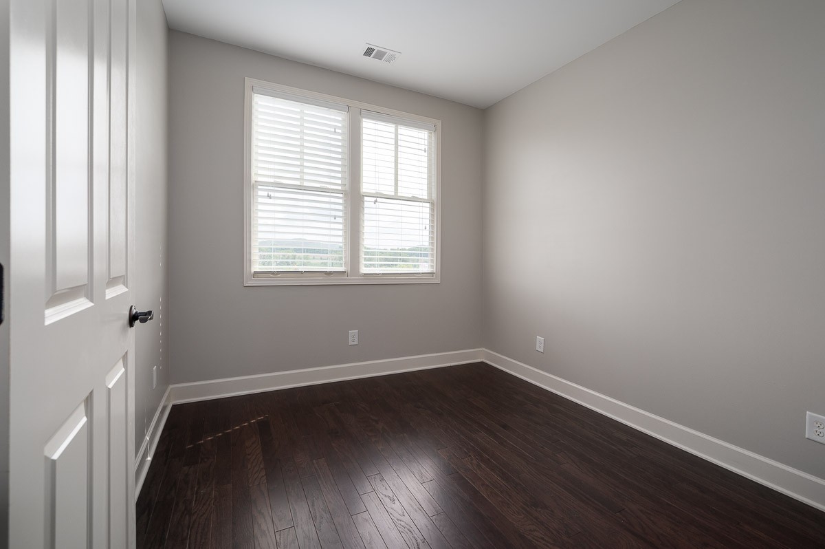 2069 Rural Plains Circle Franklin, TN 37064 - Photo 24 of 34 an empty room with wooden floor and windows