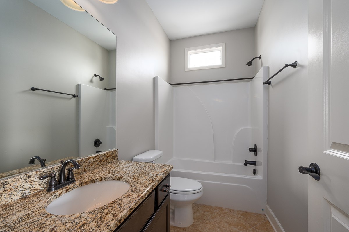 2069 Rural Plains Circle Franklin, TN 37064 - Photo 25 of 34 a bathroom with a granite countertop sink toilet and shower