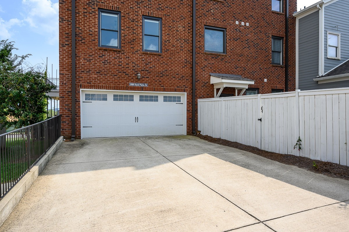 2069 Rural Plains Circle Franklin, TN 37064 - Photo 26 of 34 a view of a brick house with many windows