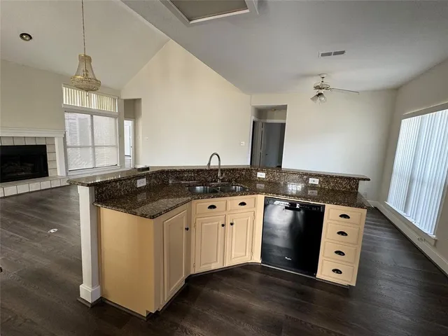 a kitchen with stainless steel appliances granite countertop a sink stove and wooden floor