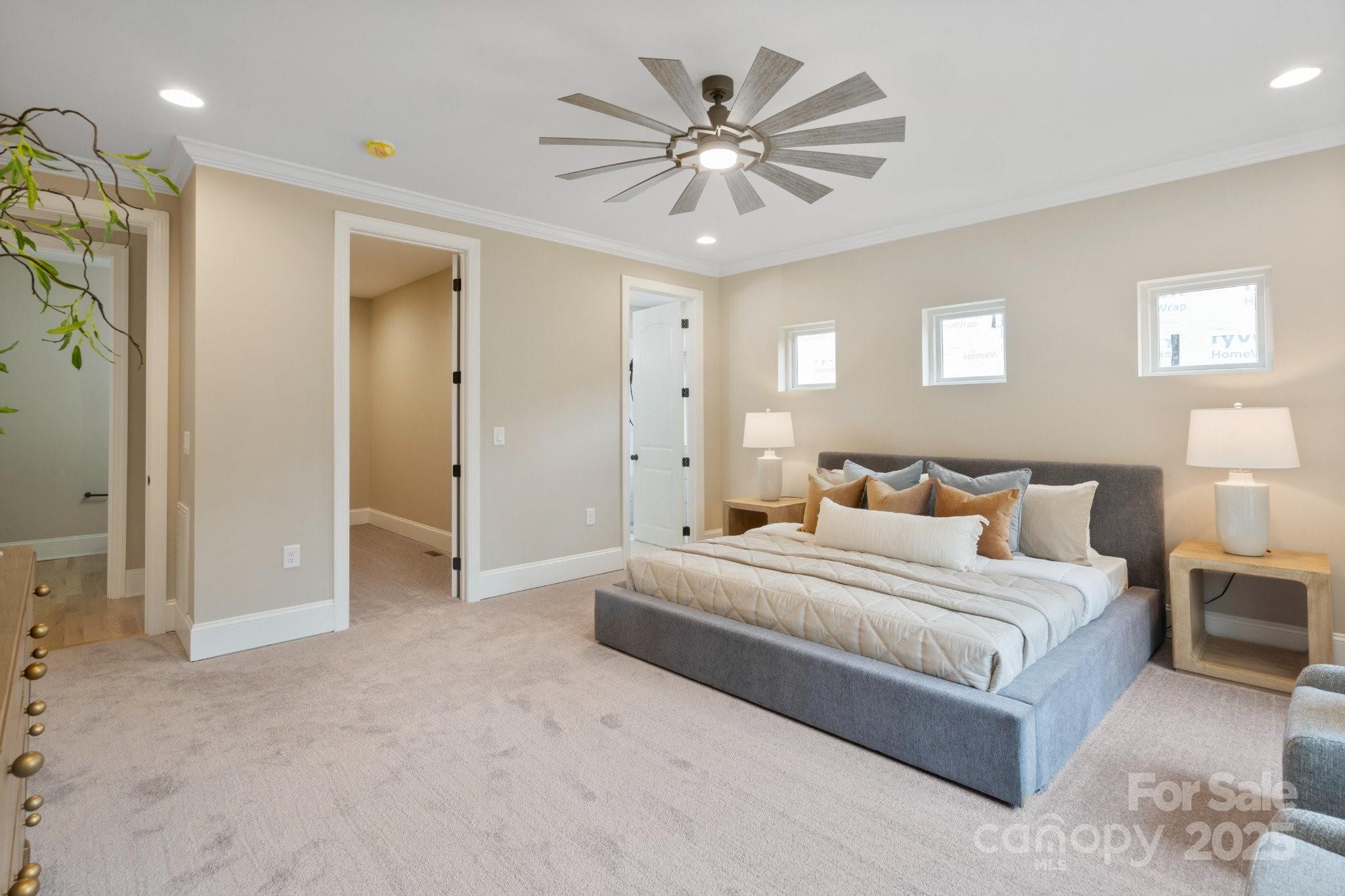 4023 Randolph Road Charlotte, NC 28211 - Photo 25 of 48 a spacious bedroom with a large bed and a chandelier