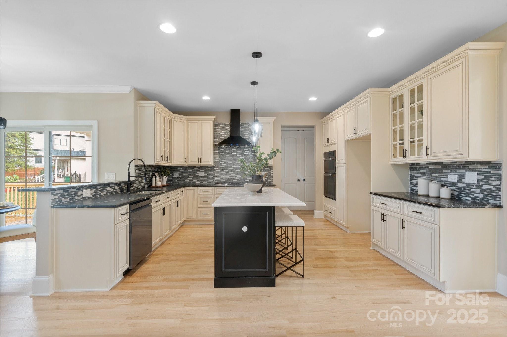 4023 Randolph Road Charlotte, NC 28211 - Photo 5 of 48 a large kitchen with stainless steel appliances kitchen island granite countertop a stove a sink dishwasher and a refrigerator