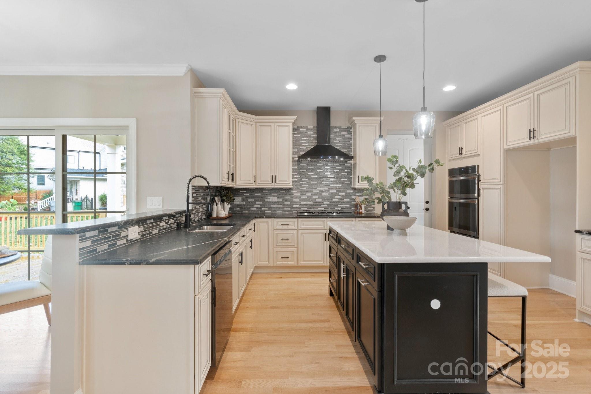 4023 Randolph Road Charlotte, NC 28211 - Photo 6 of 48 a kitchen with stainless steel appliances granite countertop a sink a stove a refrigerator and a oven with wooden floor