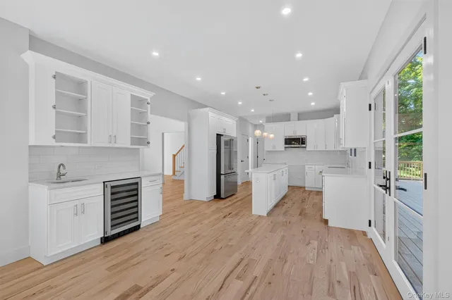 a large kitchen with a large window and stainless steel appliances