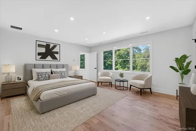 a bedroom with a large bed and a couch