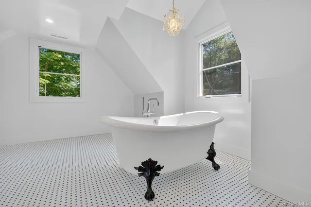 a bathroom with a sink toilet a mirror and shower