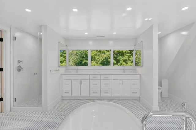 a bathroom with a bathtub and a shower
