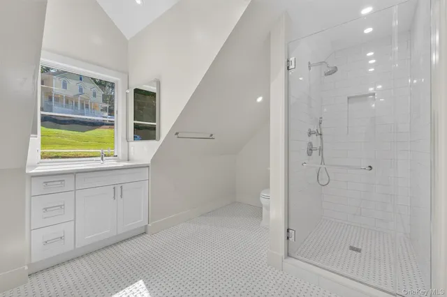 a bathroom with a shower and a sink