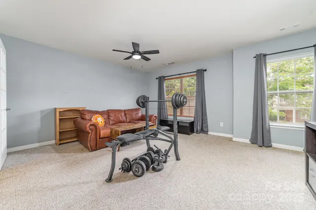 a living room with furniture a window and a chandelier