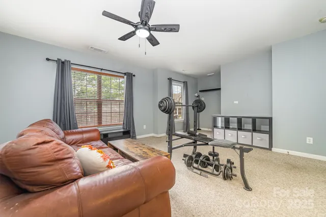 a bedroom with furniture and a large window