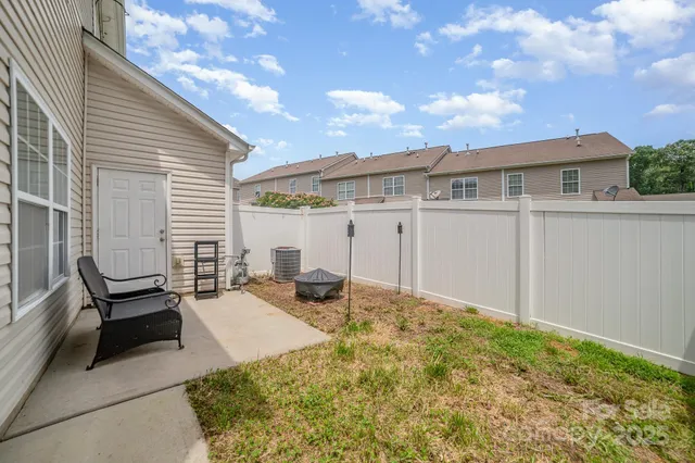 a backyard of a house with table and chairs