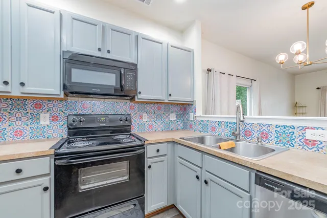 a kitchen with cabinets appliances and a sink