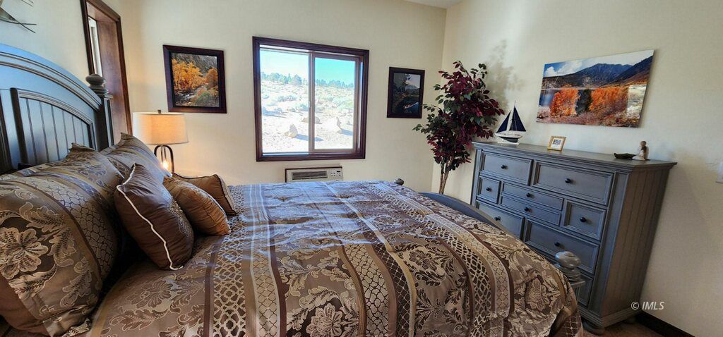 75 Ridgeview Bishop, CA 93514 - Photo 16 of 35 a bed sitting in a bedroom next to a window