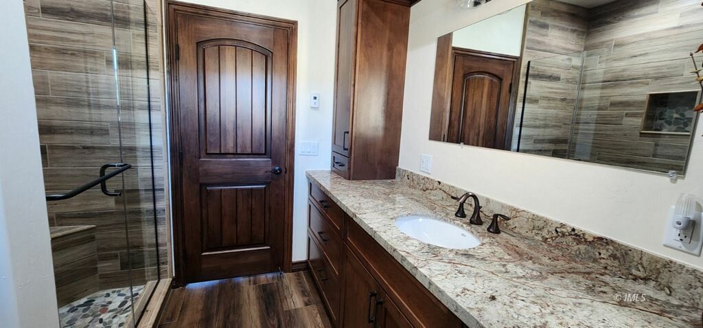 75 Ridgeview Bishop, CA 93514 - Photo 18 of 35 a bathroom with a granite countertop sink and a mirror
