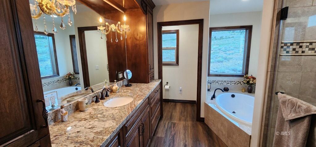 75 Ridgeview Bishop, CA 93514 - Photo 25 of 35 a bathroom with a granite countertop tub sink and mirror