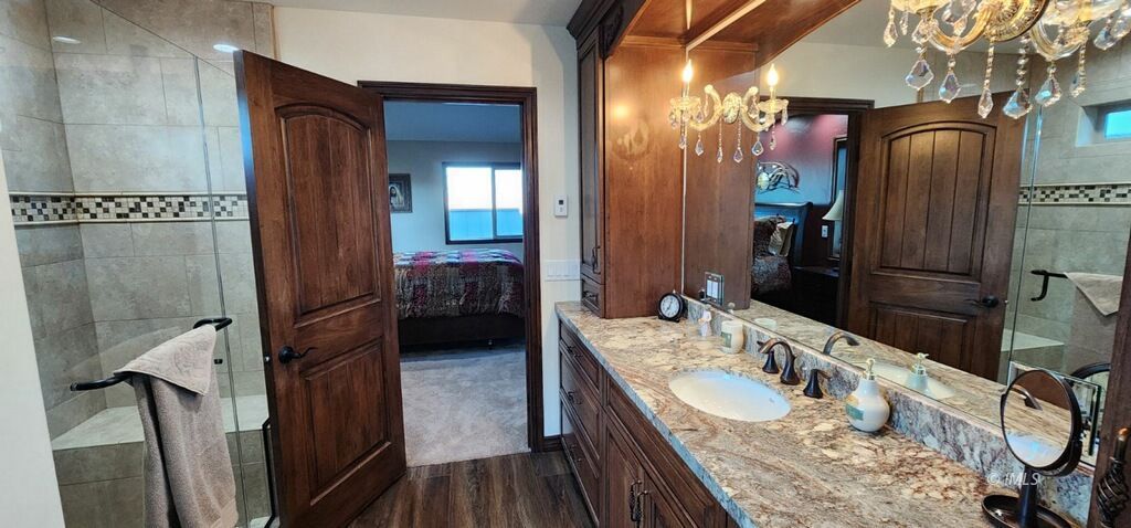 75 Ridgeview Bishop, CA 93514 - Photo 26 of 35 a en suite bathroom with a granite countertop sink a mirror and shower