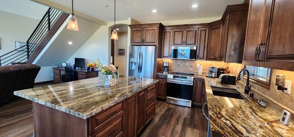 75 Ridgeview Bishop, CA 93514 - Photo 7 of 35 a kitchen with stainless steel appliances granite countertop wooden cabinets a stove top oven a sink and dishwasher
