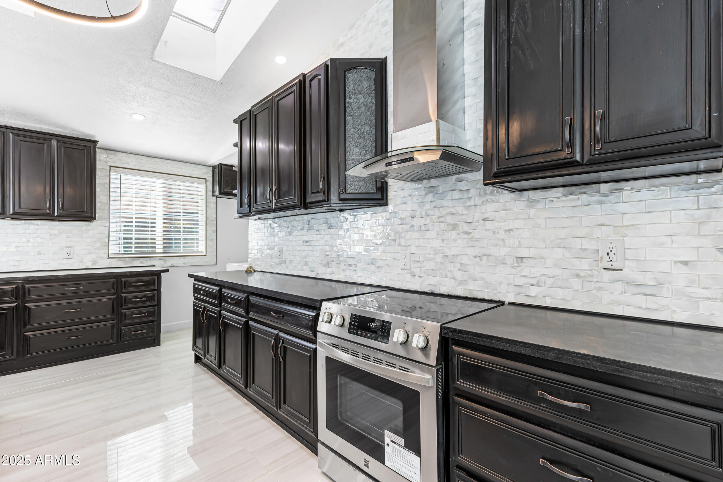 4401 West McRae Way Glendale, AZ 85308 - Photo 14 of 30 a kitchen with stainless steel appliances granite countertop a stove and a microwave