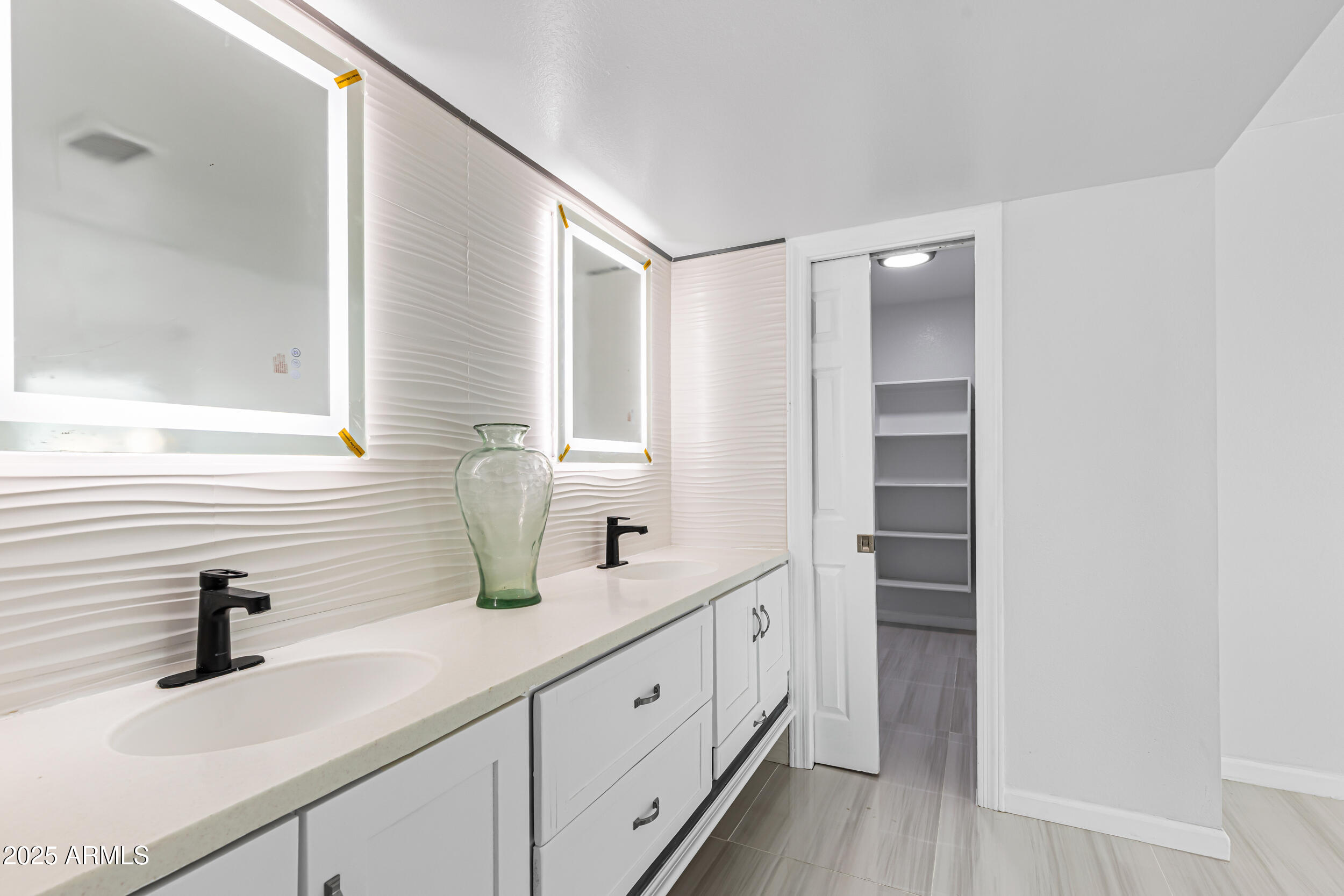 4401 West McRae Way Glendale, AZ 85308 - Photo 18 of 30 a bathroom with a double vanity sink and mirror