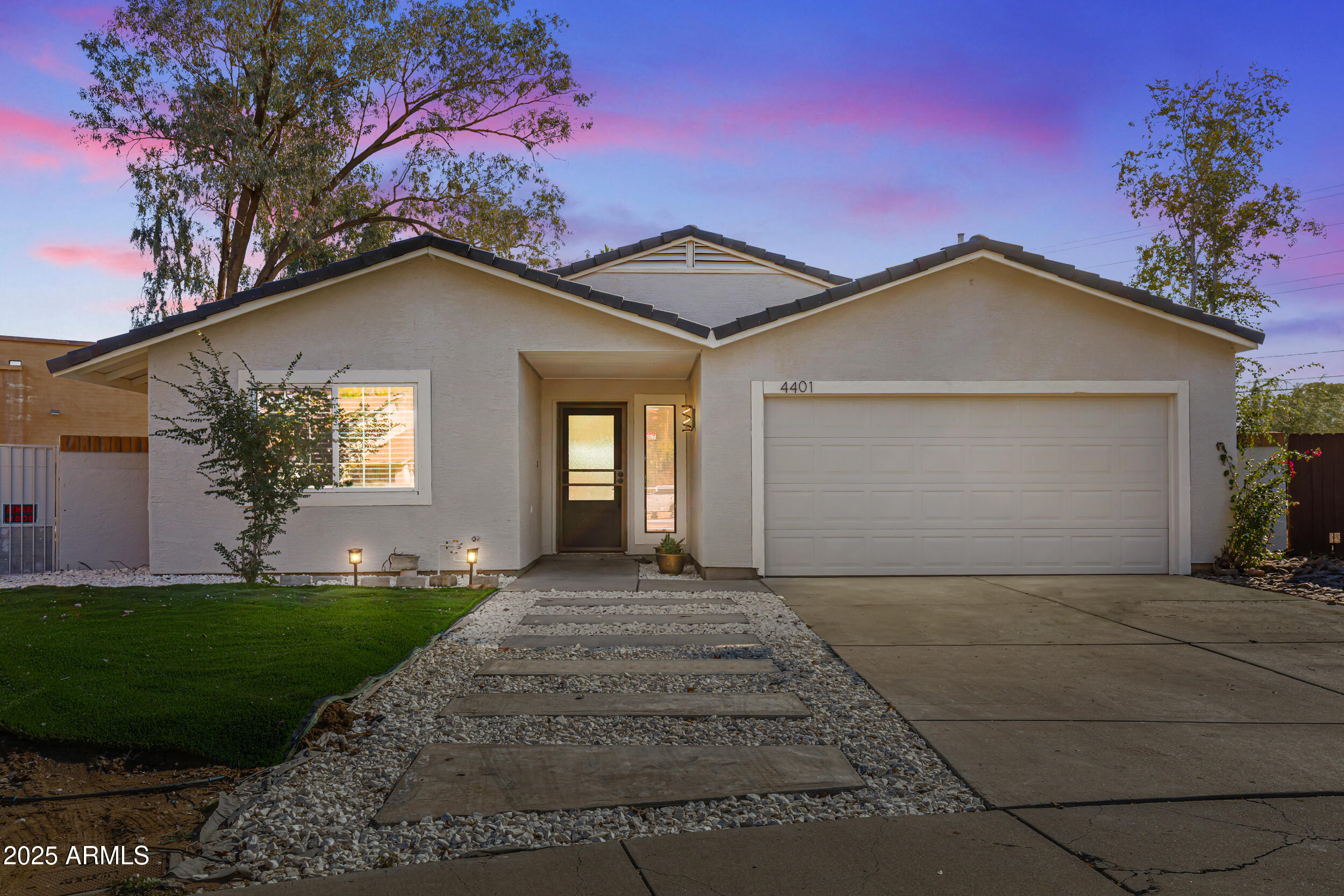 4401 West McRae Way Glendale, AZ 85308 - Photo 2 of 30 a front view of a house with a yard and garage