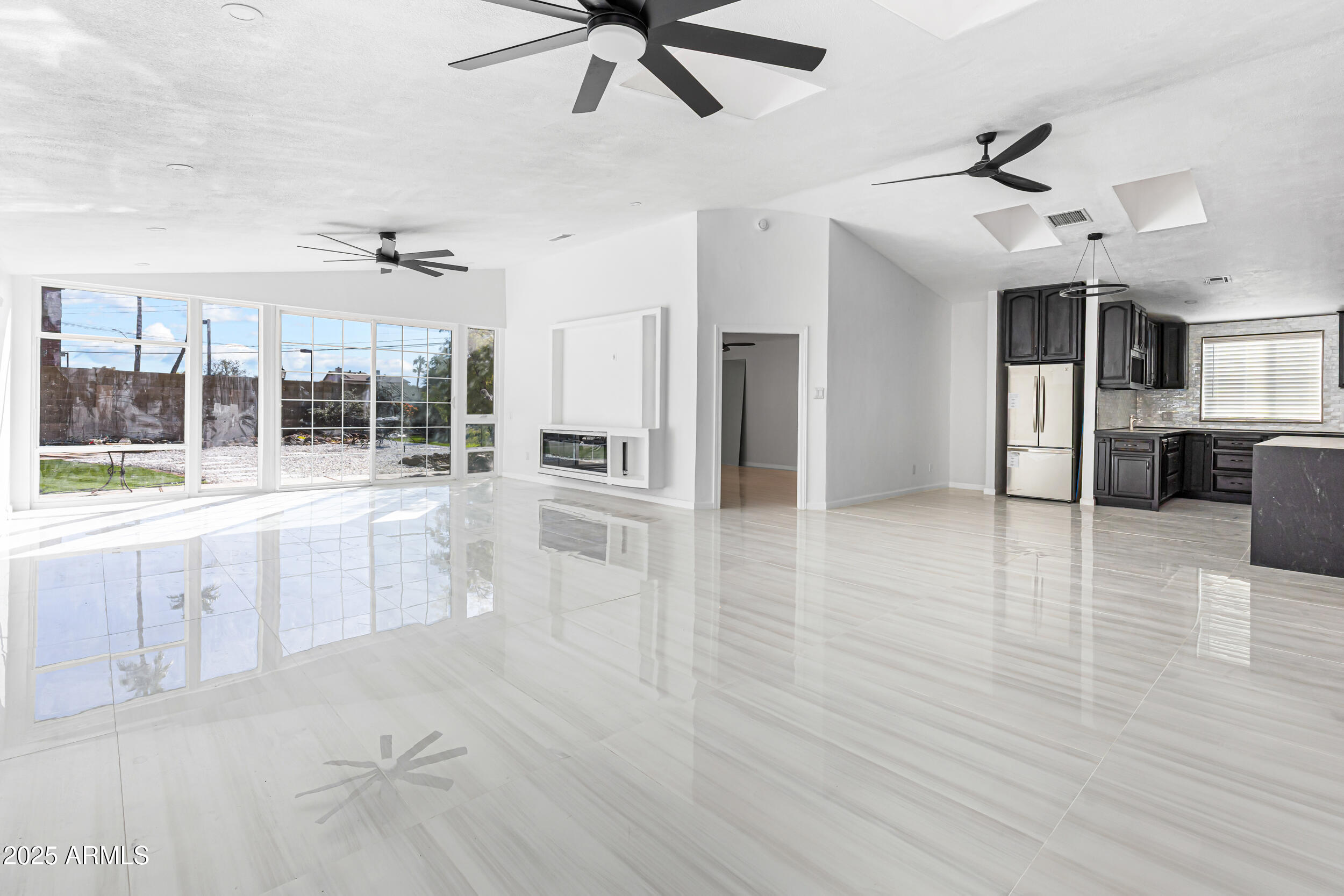 4401 West McRae Way Glendale, AZ 85308 - Photo 3 of 30 an empty room with wooden floor and windows