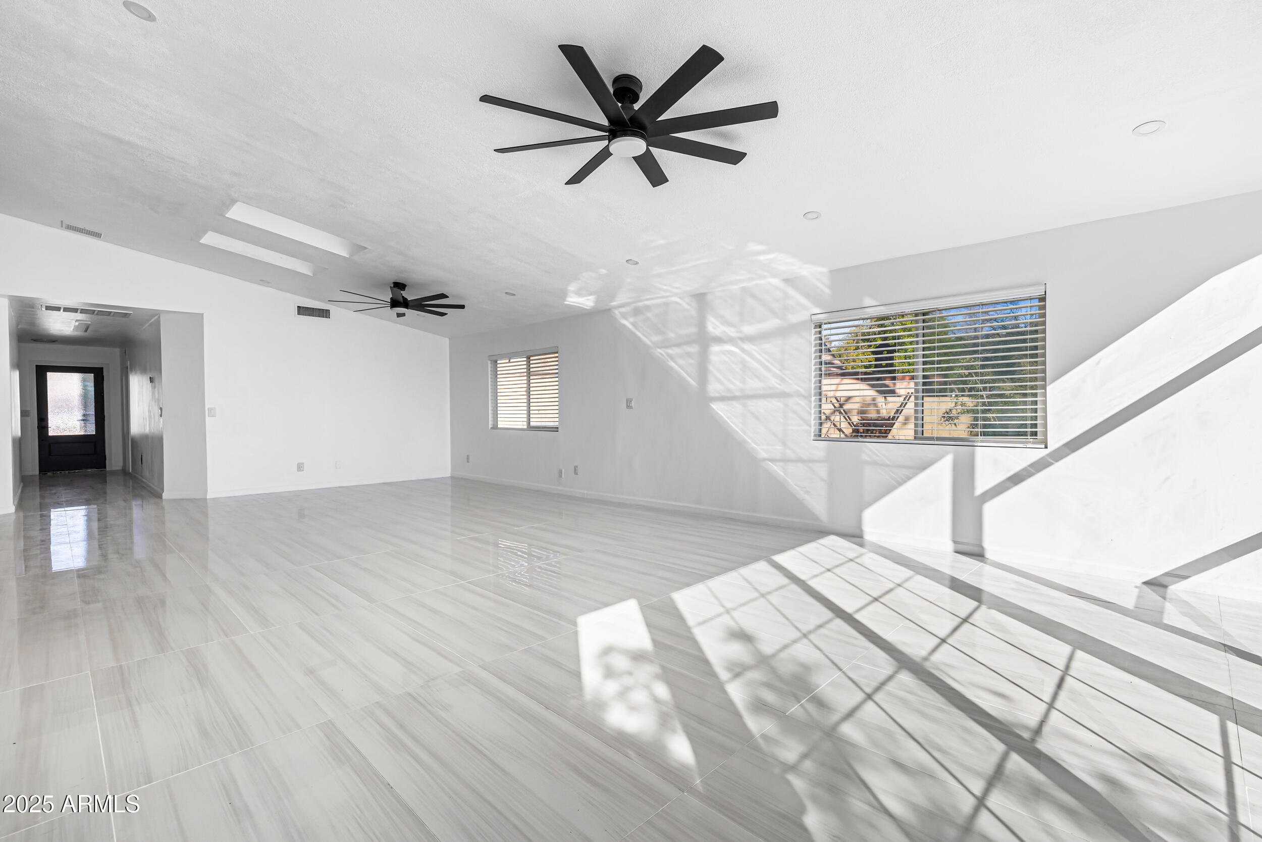 4401 West McRae Way Glendale, AZ 85308 - Photo 6 of 30 a view of empty room with wooden floor and fan