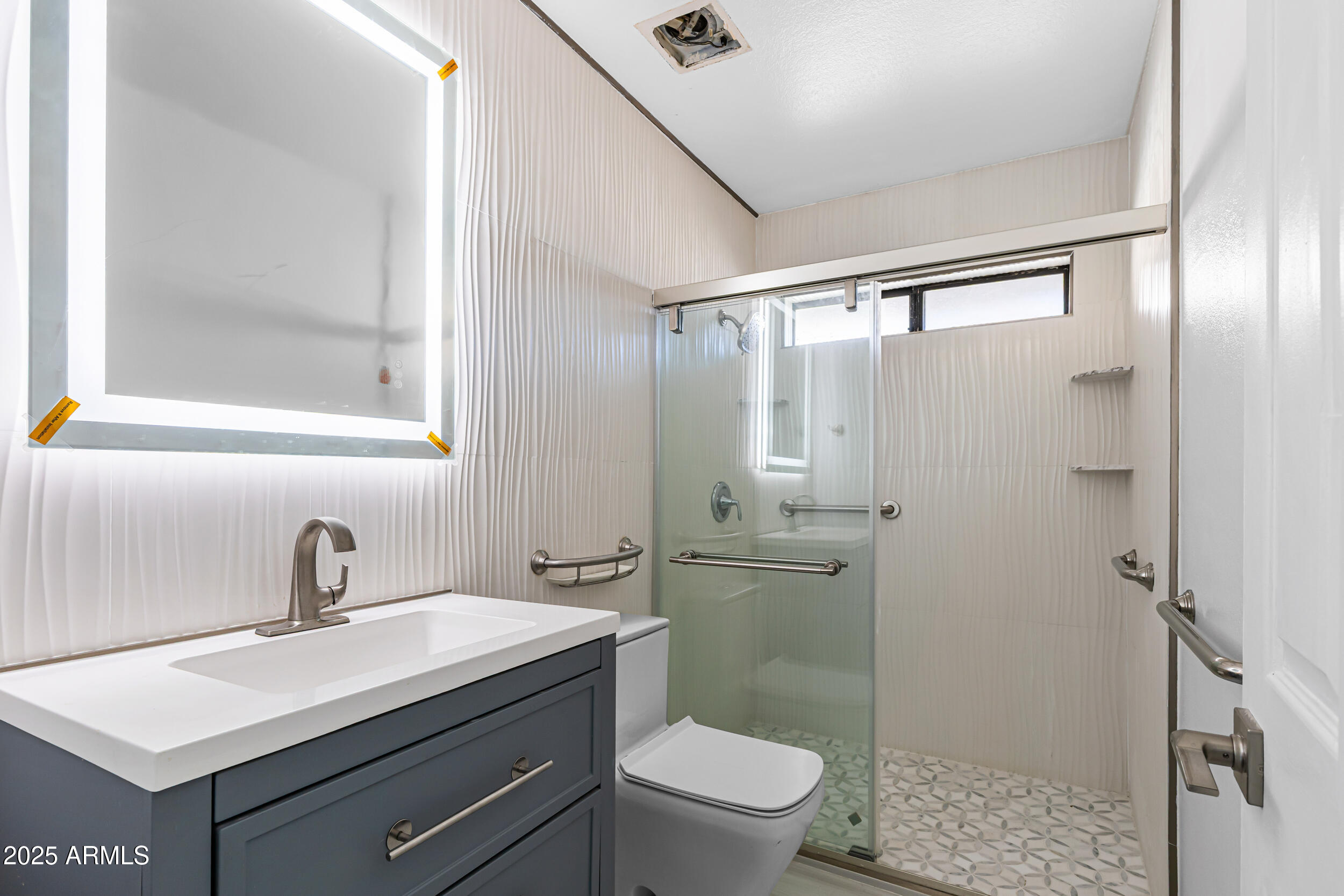 4401 West McRae Way Glendale, AZ 85308 - Photo 10 of 30 a bathroom with a sink toilet a mirror and shower