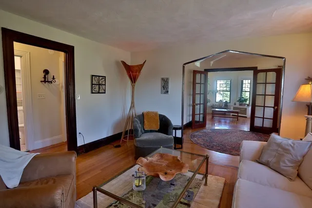 a living room with furniture and wooden floor