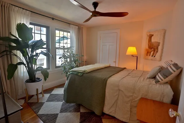 a bedroom with a bed lamp closet and large window