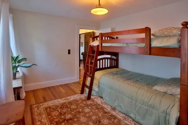 a bedroom with a bed and a potted plant