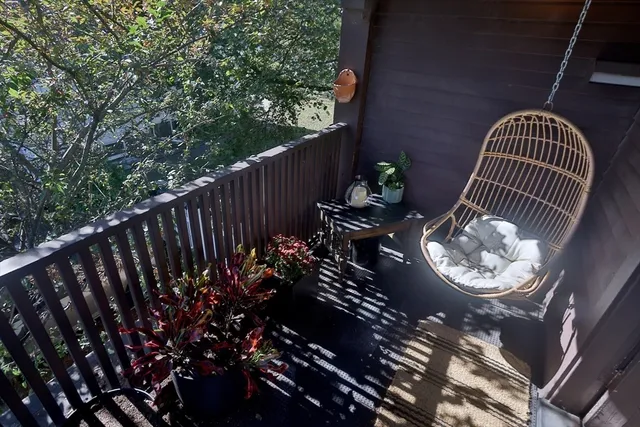 a view of a chairs and flower in the corridor