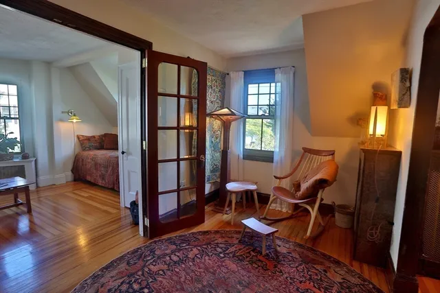 a living room with furniture rug and wooden floor