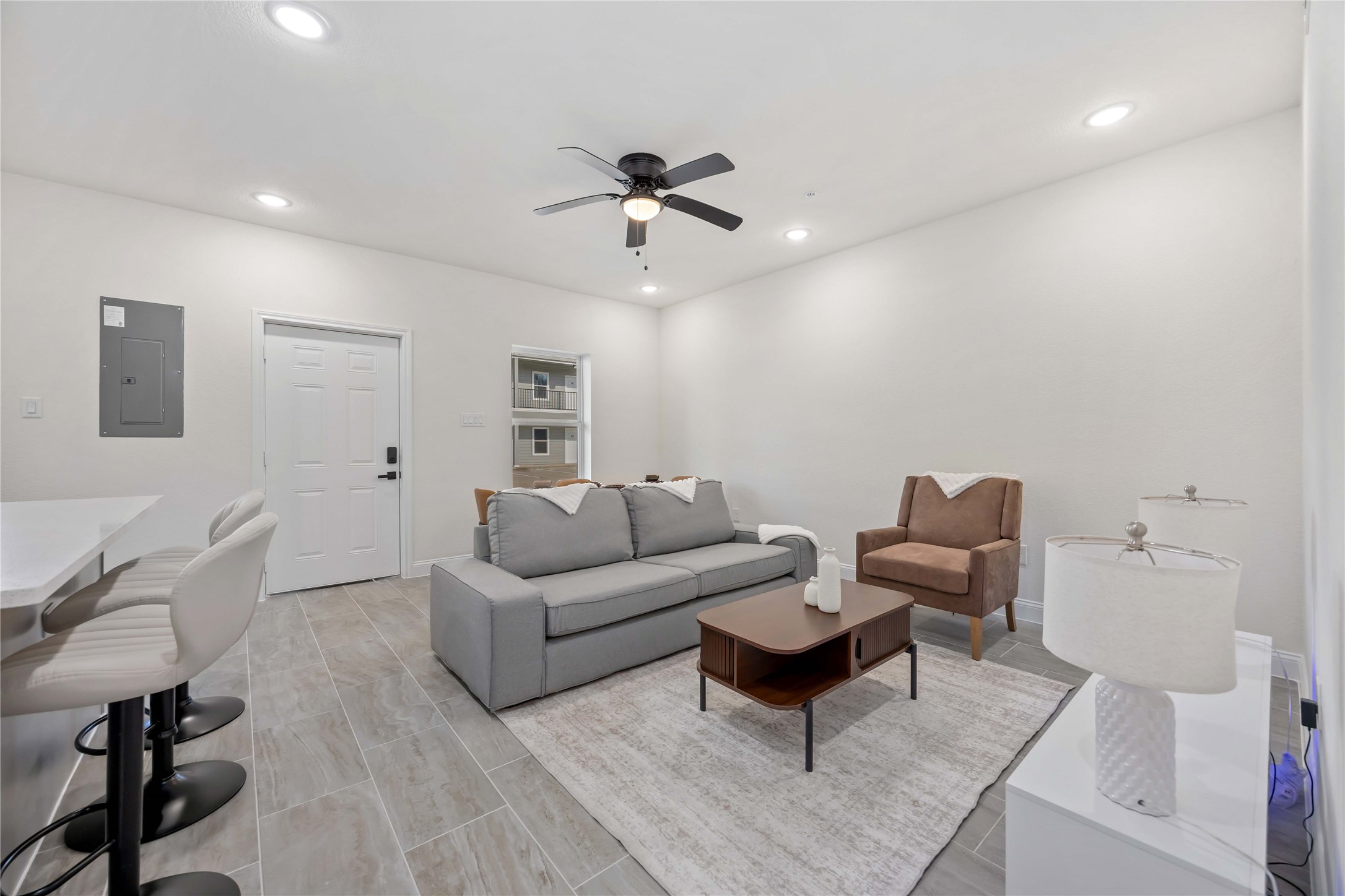 9129 Brandon Street, Unit A7 Houston, TX 77051 - Photo 5 of 15 a living room with furniture a ceiling fan and a rug